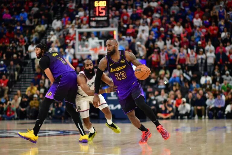 Jan 19, 2025; Inglewood, California, USA; Los Angeles Lakers forward LeBron James (23) moves the ball as forward Anthony Davis (3) provides coverage against Los Angeles Clippers guard James Harden (1) during the second half at Intuit Dome.