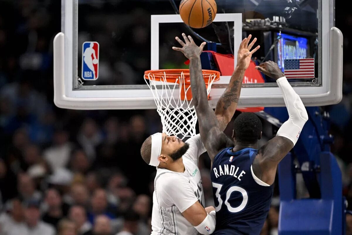 Jan 22, 2025; Dallas, Texas, USA; Minnesota Timberwolves forward Julius Randle (30) shoots the ball over Dallas Mavericks center Daniel Gafford (21) during the second half at the American Airlines Center.
