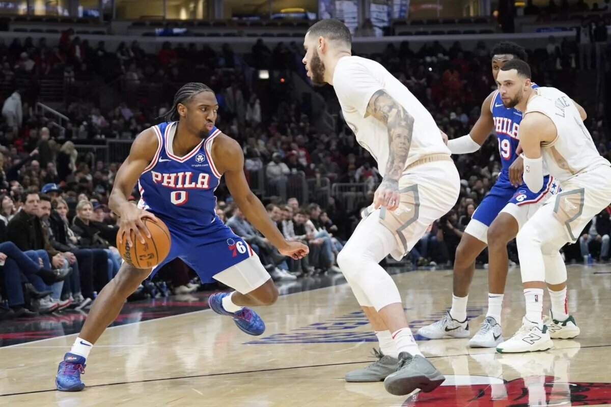 Jan 25, 2025; Chicago, Illinois, USA; Chicago Bulls guard Lonzo Ball (2) defends Philadelphia 76ers guard Tyrese Maxey (0) during the second half at United Center.