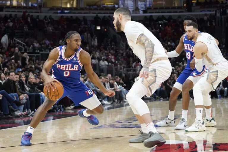 Jan 25, 2025; Chicago, Illinois, USA; Chicago Bulls guard Lonzo Ball (2) defends Philadelphia 76ers guard Tyrese Maxey (0) during the second half at United Center.