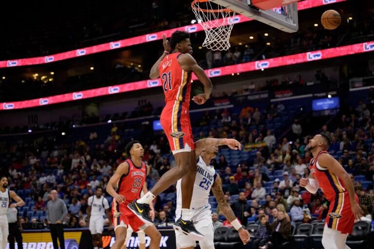 Jan 29, 2025; New Orleans, Louisiana, USA; Dallas Mavericks forward P.J. Washington (25) has his shot swatted away by New Orleans Pelicans center Yves Missi (21) during the first half at Smoothie King Center.