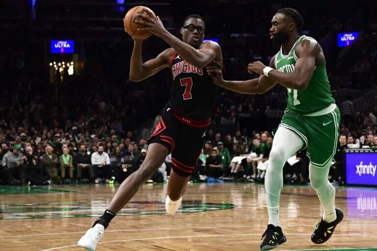 Jan 29, 2025; Boston, Massachusetts, USA; Chicago Bulls forward Jalen Smith (7) controls the ball while Boston Celtics guard Jaylen Brown (7) defends during the second half at TD Garden.