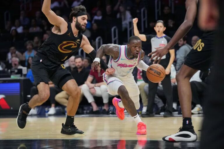 Jan 29, 2025; Miami, Florida, USA; Miami Heat guard Terry Rozier (2) drives to the basket and gets fouled by Cleveland Cavaliers guard Max Strus (1) during the second half at Kaseya Center.
