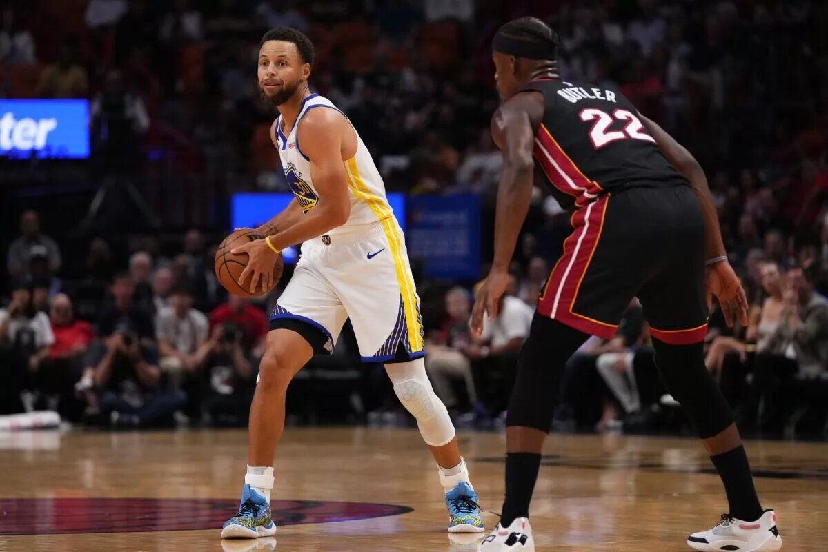 Miami Heat forward Jimmy Butler guards Golden State Warriors champion Stephen Curry