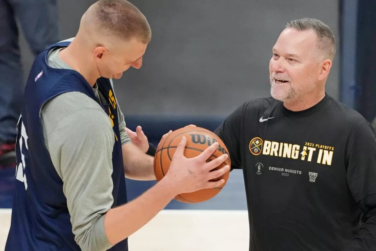 Denver Nuggets center Nikola Jokic (15) talks with head coach Michael Malone