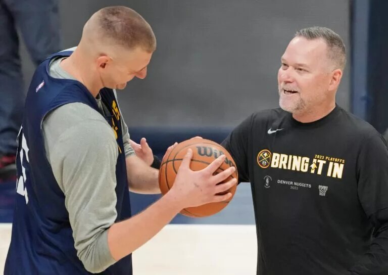 Denver Nuggets center Nikola Jokic (15) talks with head coach Michael Malone