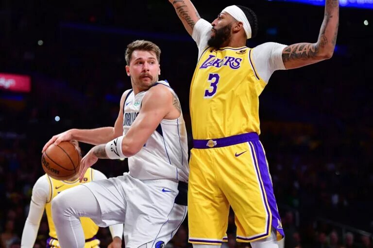 Los Angeles Lakers (Dallas Mavericks) guard Luka Doncic makes pass against Dallas Mavericks (Los Angeles Lakers) center Anthony Davis