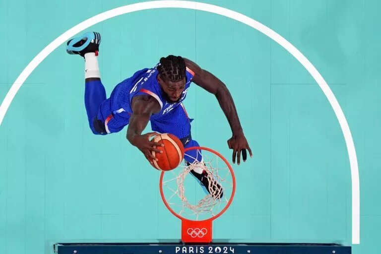 France centre Mathias Lessort (26) dunks the ball against Japan in men’s basketball group B play during the Paris 2024 Olympic Summer Games at Stade Pierre-Mauroy.
