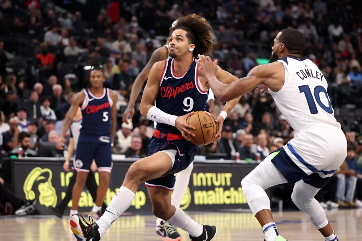 Dec 4, 2024; Inglewood, California, USA; Los Angeles Clippers guard Trentyn Flowers (9) drives to the basket against Minnesota Timberwolves guard Mike Conley (10) during the fourth quarter at Intuit Dome.