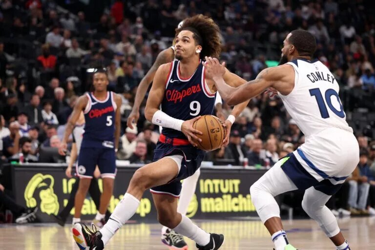 Dec 4, 2024; Inglewood, California, USA; Los Angeles Clippers guard Trentyn Flowers (9) drives to the basket against Minnesota Timberwolves guard Mike Conley (10) during the fourth quarter at Intuit Dome.