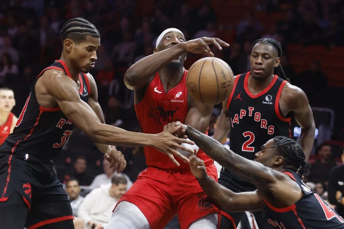 Toronto Raptors defenders led by Davion Mitchell attempt to stop Miami Heat big man Bam Adebayo