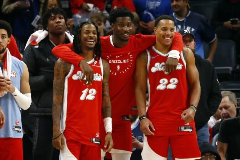 Dec 19, 2024; Memphis, Tennessee, USA; Memphis Grizzlies guard Ja Morant (left), forward Jaren Jackson Jr. (middle) and guard Desmond Bane (right) react during the fourth quarter against the Golden State Warriors at FedExForum.