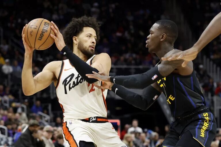Jan 9, 2025; Detroit, Michigan, USA; Detroit Pistons guard Cade Cunningham (2) is defended by Golden State Warriors guard Dennis Schroder (71) in the first half at Little Caesars Arena. Mandatory Credit: Rick Osentoski-Imagn Images