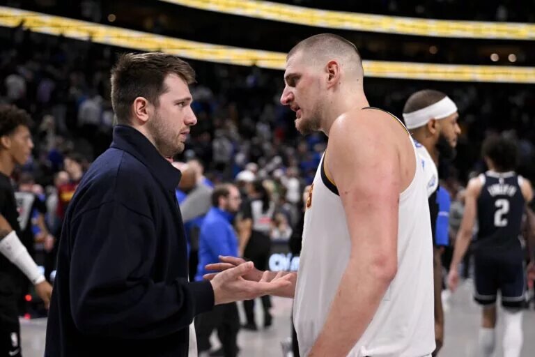 Denver Nuggets center Nikola Jokic speaks with Los Angeles Lakers guard Luka Doncic before Dallas Mavericks trade
