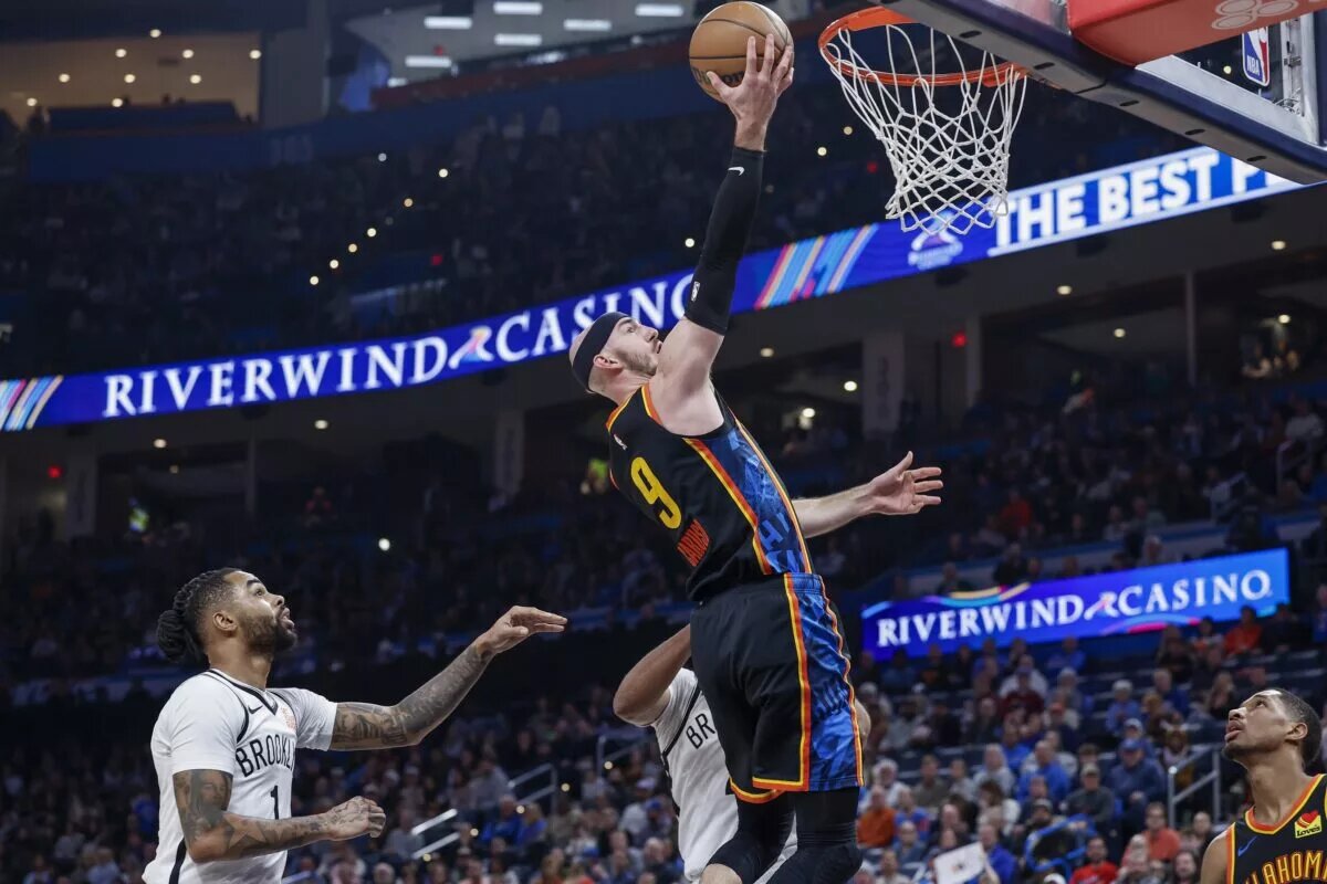 Jan 19, 2025; Oklahoma City, Oklahoma, USA; Oklahoma City Thunder guard Alex Caruso (9) goes up for a basket in front of Brooklyn Nets guard D'Angelo Russell (1) during the second half at Paycom Center. Mandatory Credit: Alonzo Adams-Imagn Images