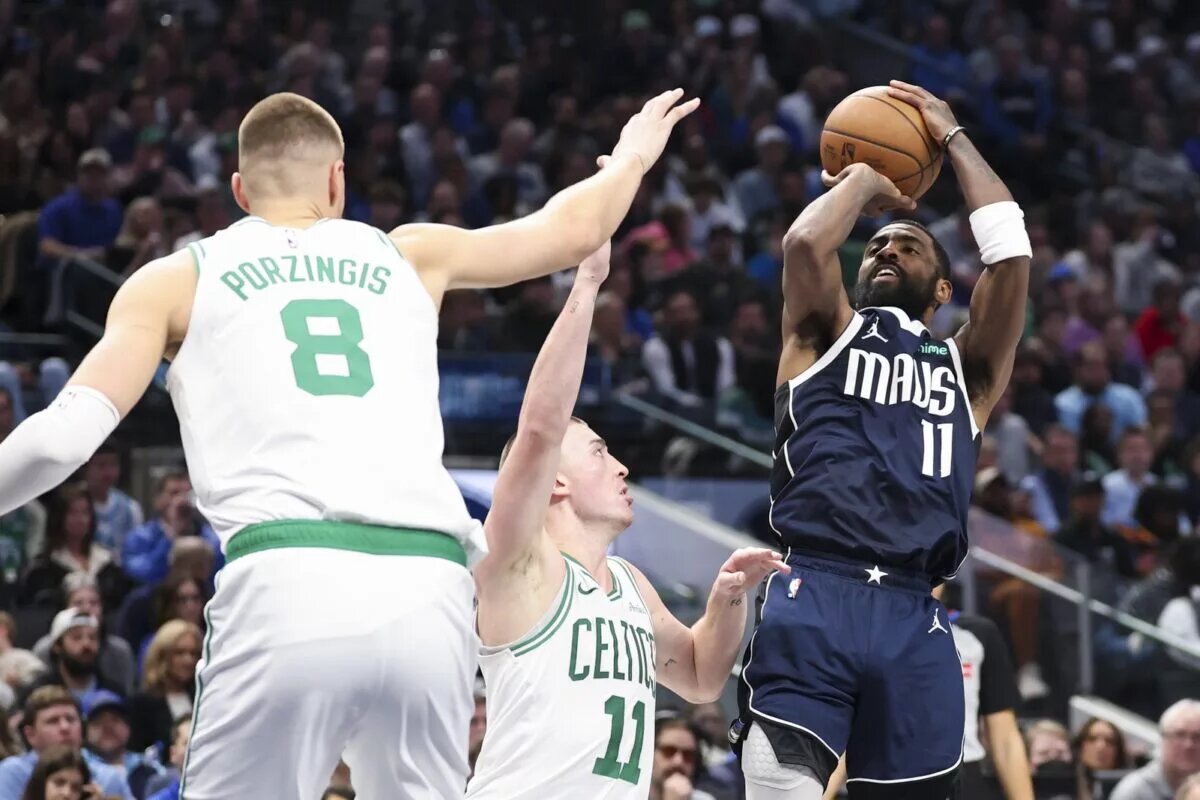 Kyrie Irving attempts to score against the Celtics