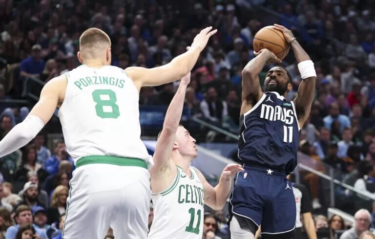 Kyrie Irving attempts to score against the Celtics