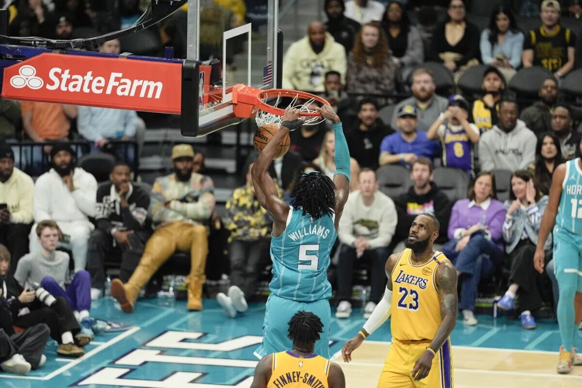Jan 27, 2025; Charlotte, North Carolina, USA; Charlotte Hornets center Mark Williams (5) dunks the ball against Los Angeles Lakers forward LeBron James (23) during the second half at the Spectrum Center. Mandatory Credit: Jim Dedmon-Imagn Images