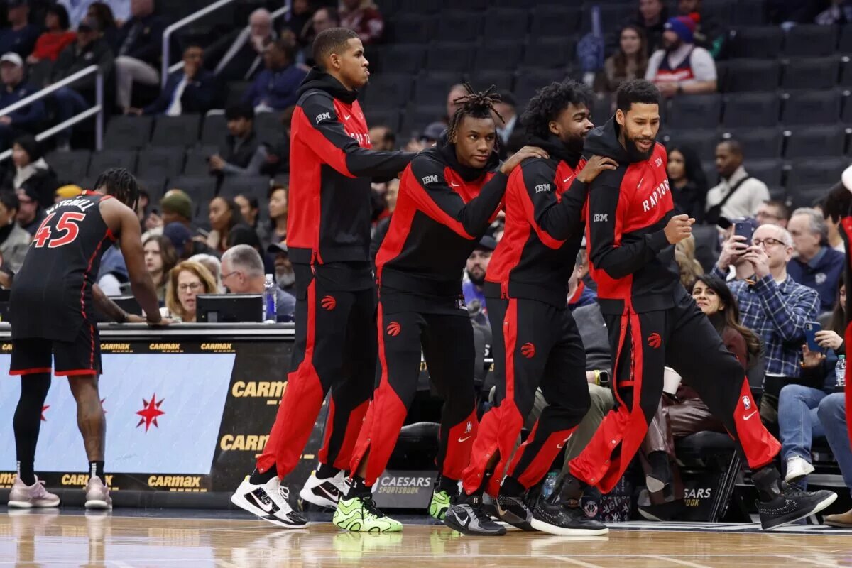 Toronto Raptors players dance near bench