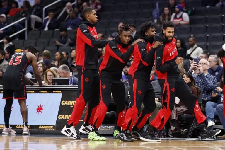 Toronto Raptors players dance near bench