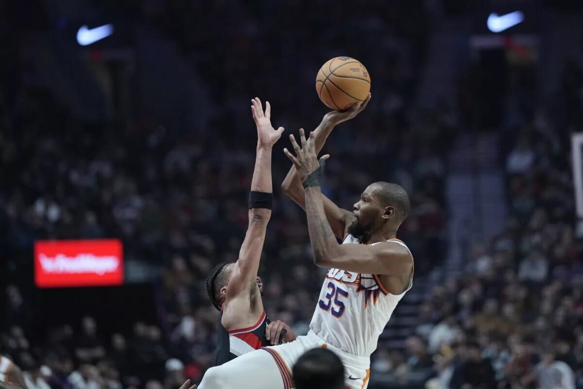 Phoenix Suns forward Kevin Durant shoots over the top over defender
