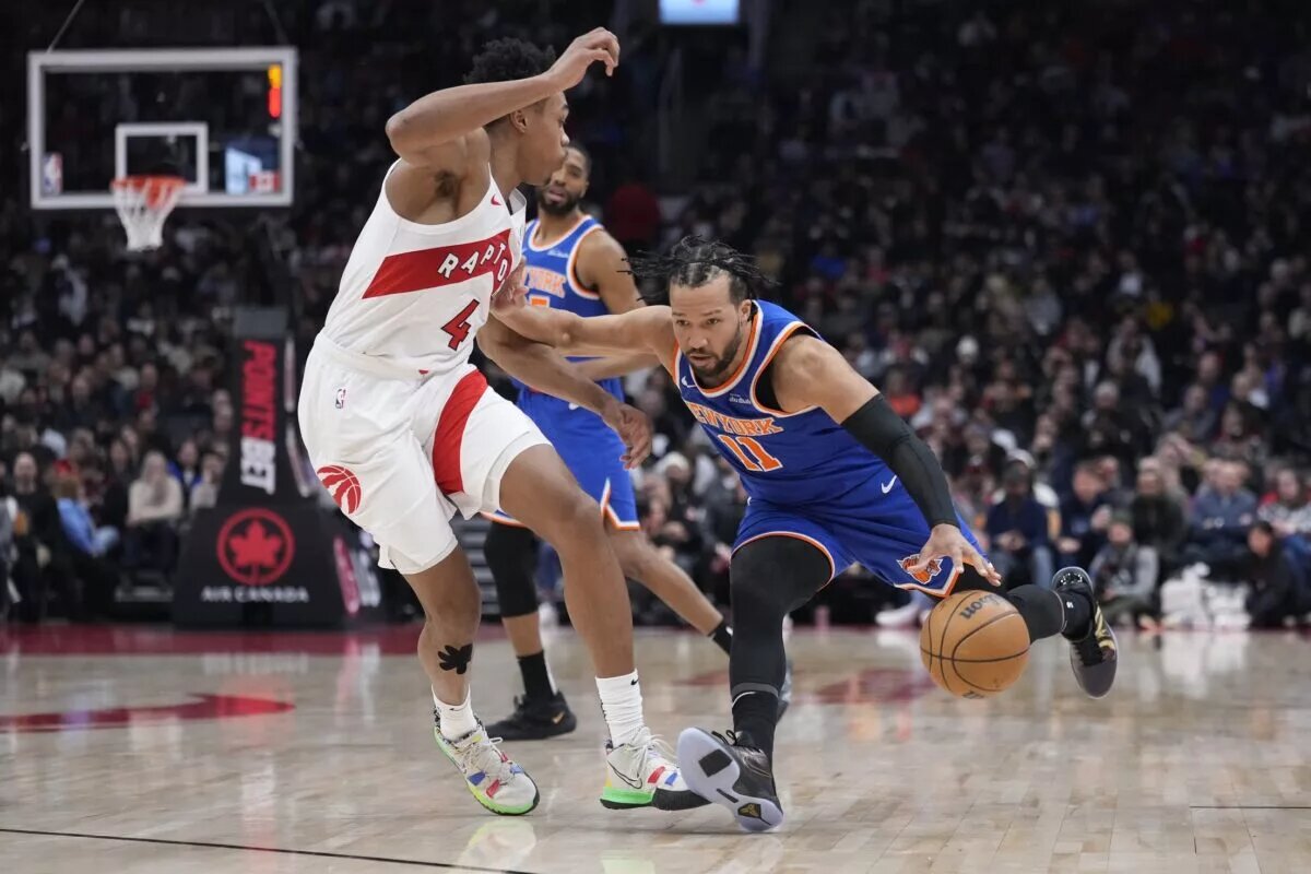 Feb 4, 2025; Toronto, Ontario, CAN; New York Knicks guard Jalen Brunson (11) drives to the net against Toronto Raptors forward Scottie Barnes (4) during the first half at Scotiabank Arena. Mandatory Credit: John E. Sokolowski-Imagn Images