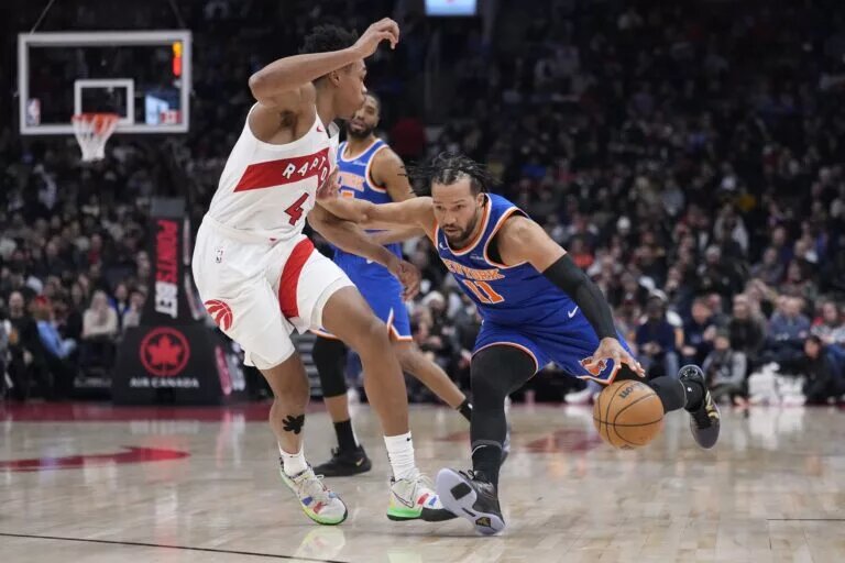 Feb 4, 2025; Toronto, Ontario, CAN; New York Knicks guard Jalen Brunson (11) drives to the net against Toronto Raptors forward Scottie Barnes (4) during the first half at Scotiabank Arena. Mandatory Credit: John E. Sokolowski-Imagn Images