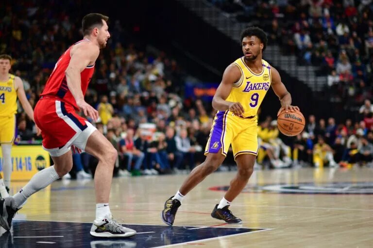 Feb 4, 2025; Inglewood, California, USA; Los Angeles Lakers guard Bronny James (9) controls the ball against Los Angeles Clippers forward Drew Eubanks (15) during the second half at Intuit Dome. Mandatory Credit: Gary A. Vasquez-Imagn Images