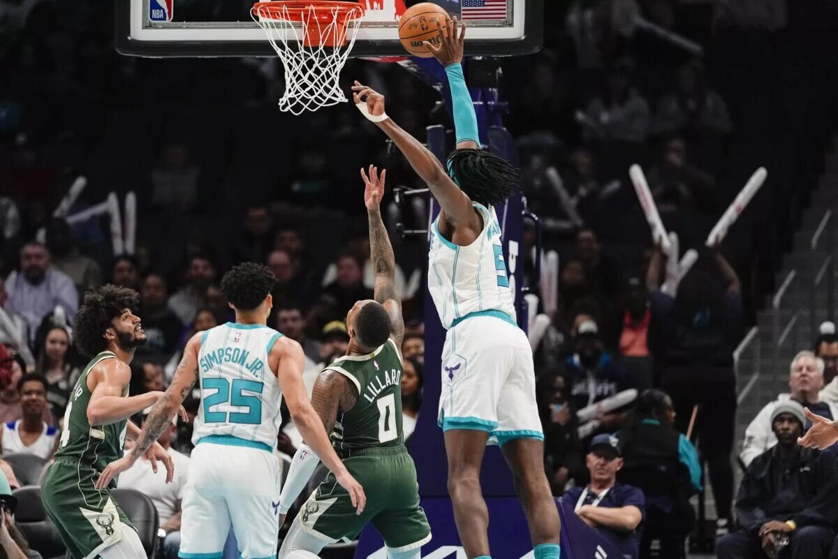 Feb 5, 2025; Charlotte, North Carolina, USA; Charlotte Hornets center Mark Williams (5) tries for the block on Milwaukee Bucks guard Damian Lillard (0) during the second half at Spectrum Center.