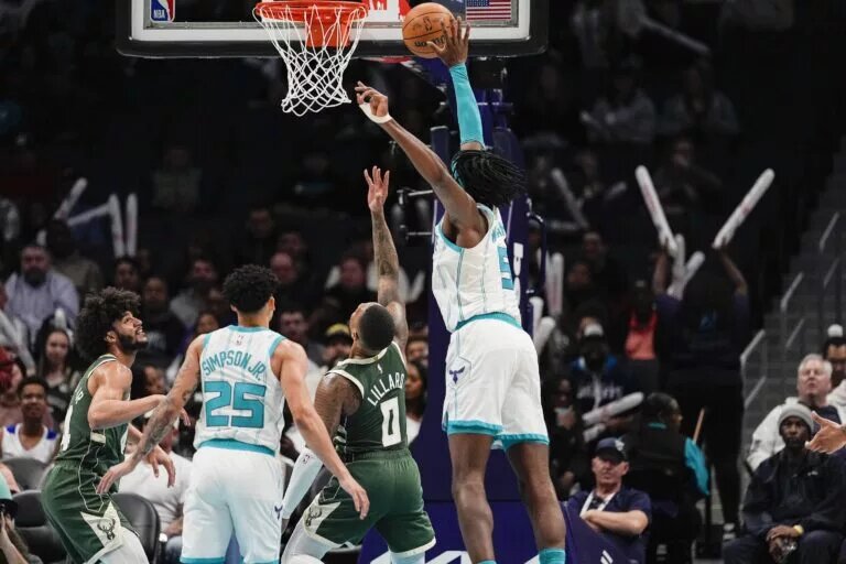Feb 5, 2025; Charlotte, North Carolina, USA; Charlotte Hornets center Mark Williams (5) tries for the block on Milwaukee Bucks guard Damian Lillard (0) during the second half at Spectrum Center.