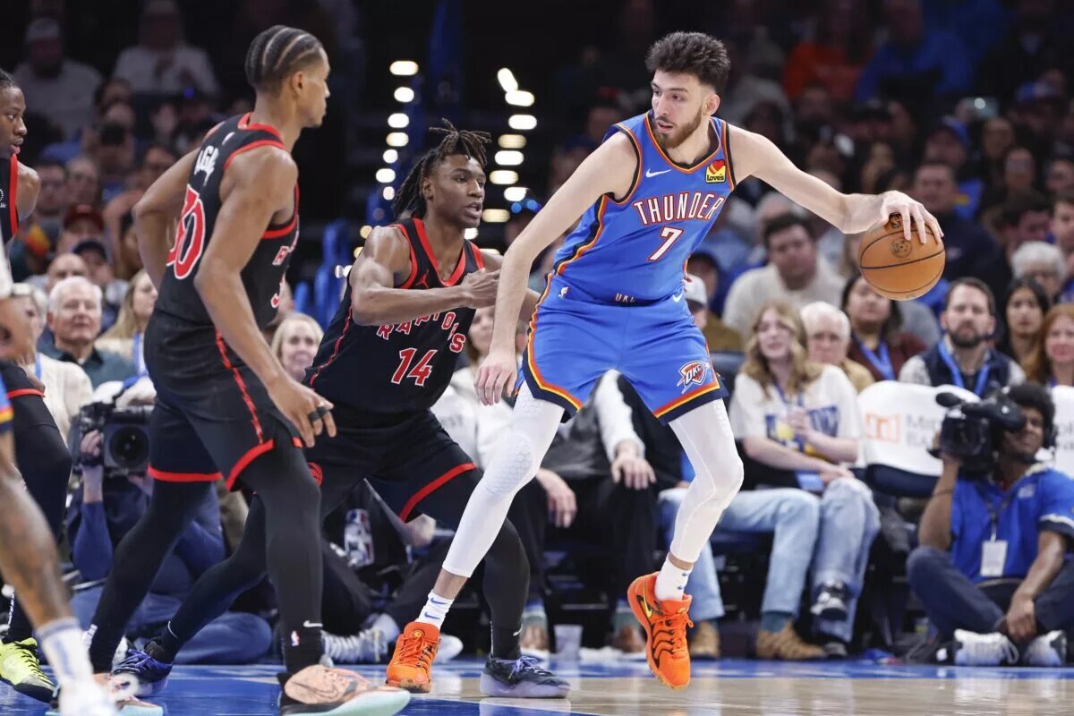 Oklahoma City Thunder forward Chet Holmgren (7) moves the ball against Toronto Raptors guard JaKobe Walter (14) during the second half at Paycom Center.