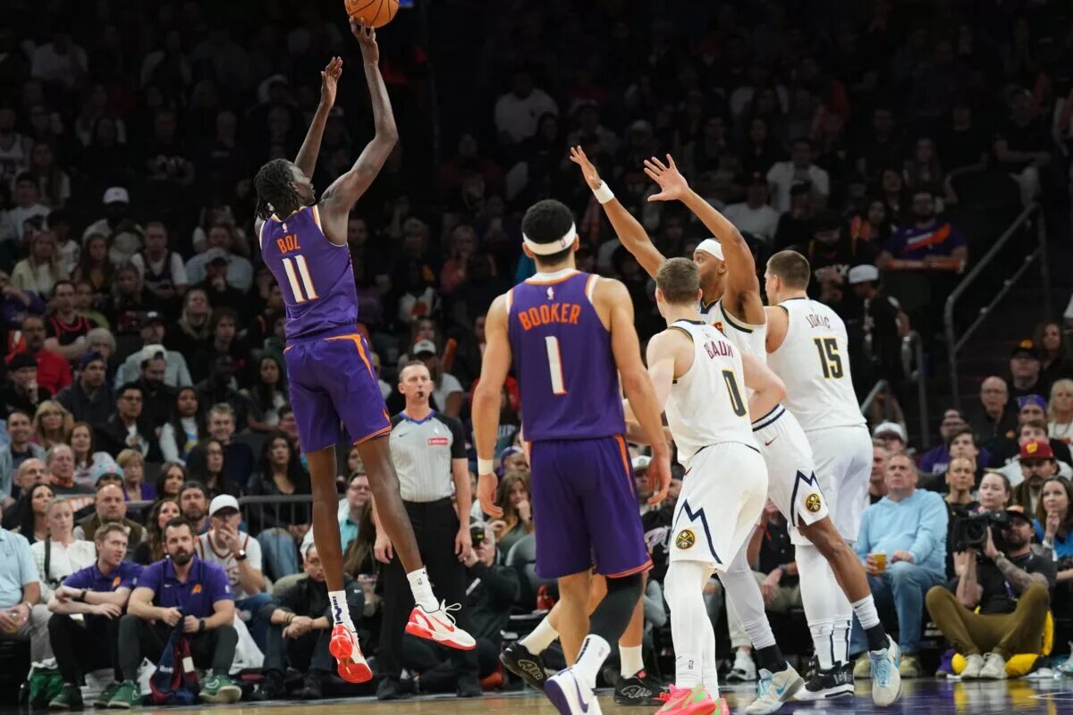 Phoenix Suns fan favorite Bol Bol shoots over the top of the Denver Nuggets defense