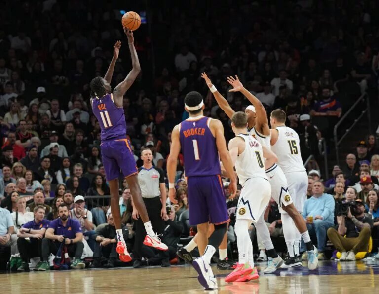 Phoenix Suns fan favorite Bol Bol shoots over the top of the Denver Nuggets defense
