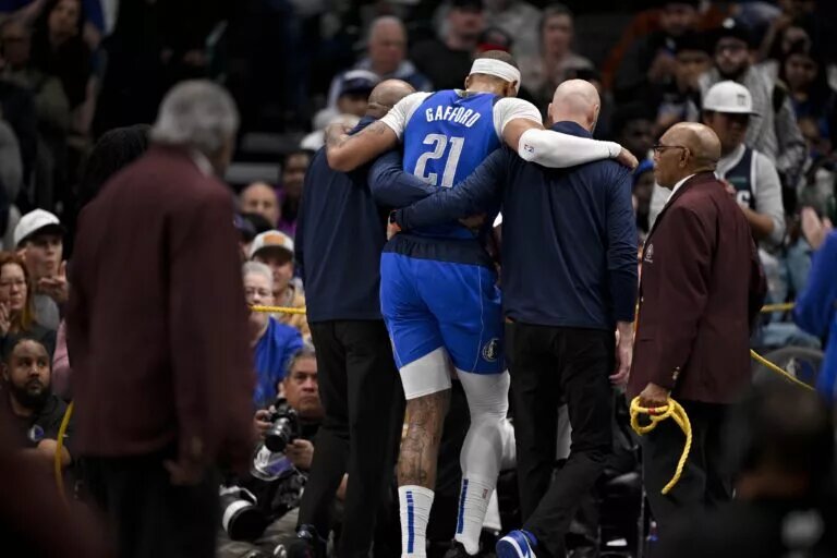 Dallas Mavericks center Daniel Gafford being helped off floor