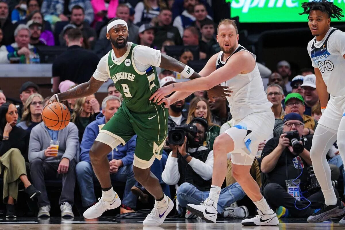 Feb 12, 2025; Minneapolis, Minnesota, USA; Milwaukee Bucks forward Bobby Portis (9) dribbles against the Minnesota Timberwolves guard Joe Ingles (7) in the second quarter at Target Center.