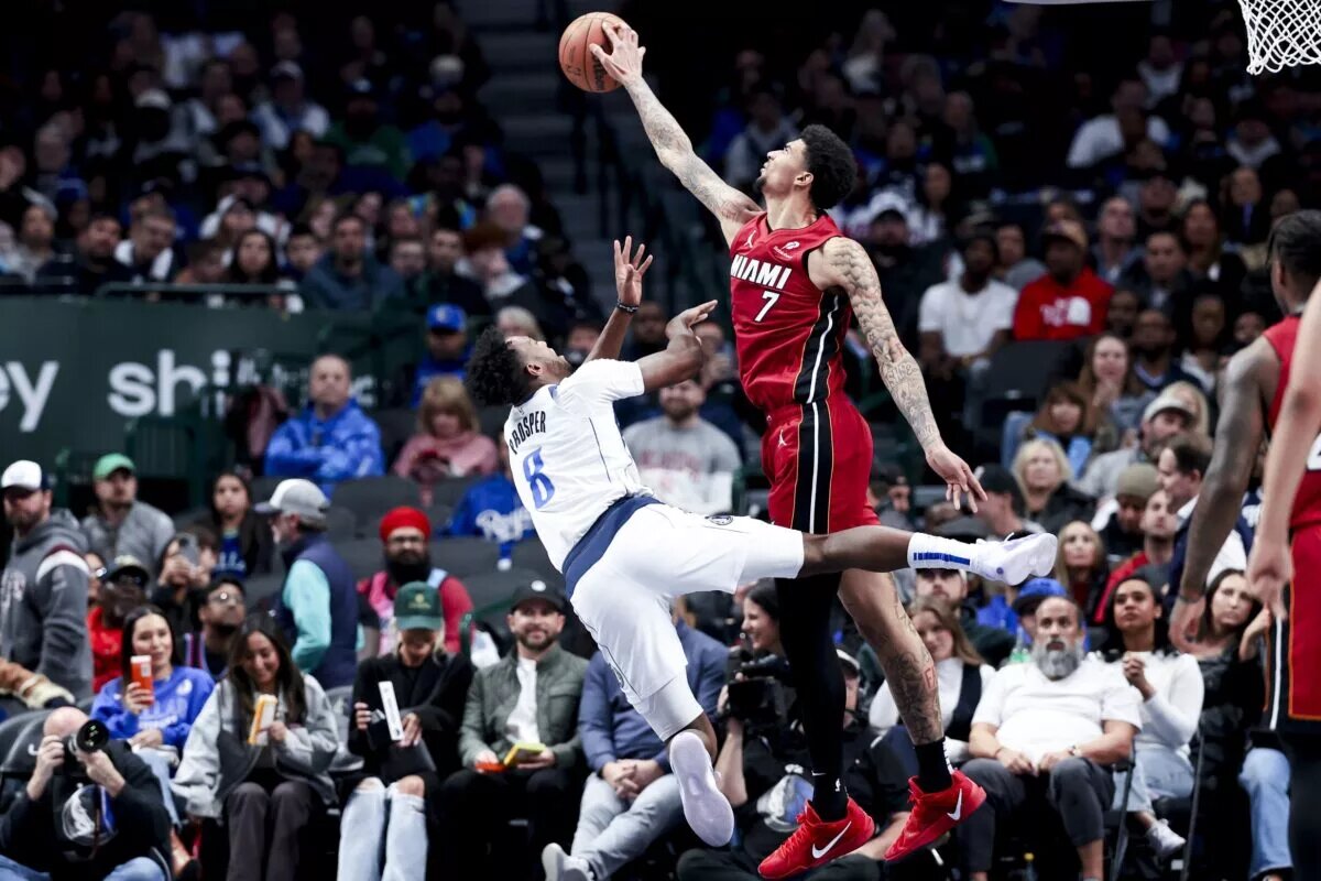 Feb 13, 2025; Dallas, Texas, USA; Miami Heat center Kel'el Ware (7) blocks teh shot of Dallas Mavericks forward Olivier-Maxence Prosper (8) during the second half at American Airlines Center.