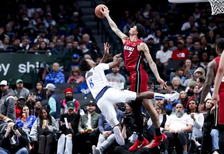 Feb 13, 2025; Dallas, Texas, USA; Miami Heat center Kel'el Ware (7) blocks teh shot of Dallas Mavericks forward Olivier-Maxence Prosper (8) during the second half at American Airlines Center.