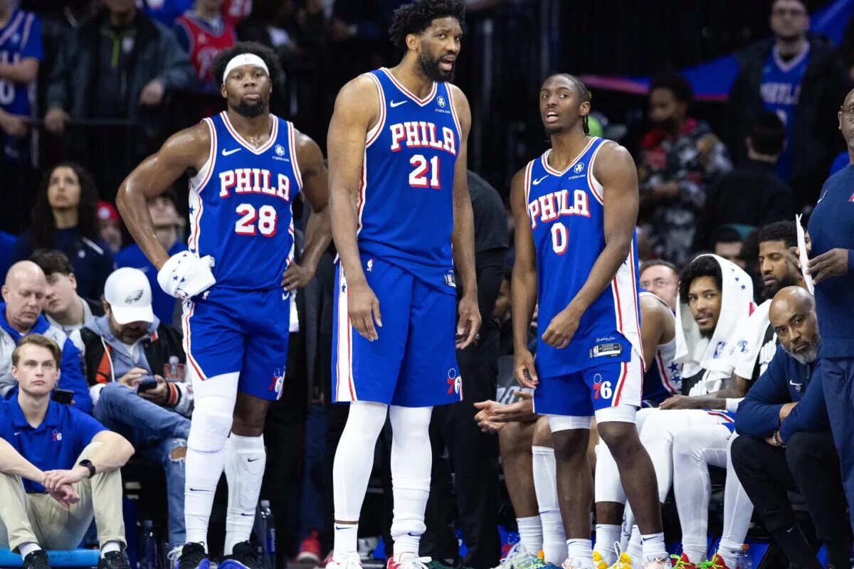 Philadelphia 76ers players look on during game