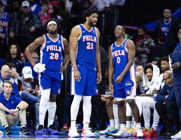 Philadelphia 76ers players look on during game