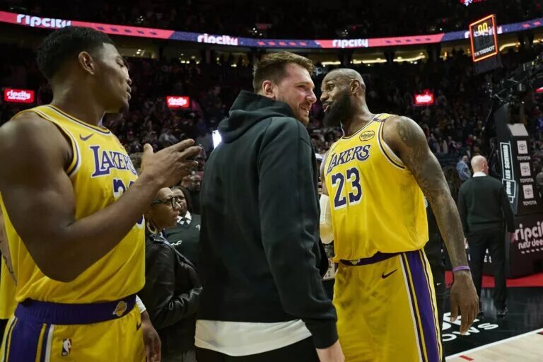 Los Angeles Lakers forward LeBron James (23) celebrates with guard Luka Doncic (77) and forward Rui Hachimura