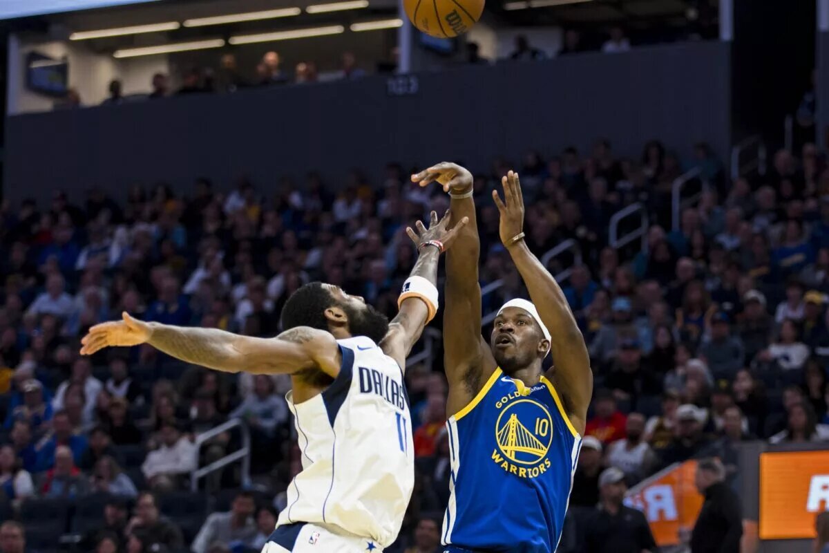 Feb 23, 2025; San Francisco, California, USA; Dallas Mavericks guard Kyrie Irving (11) defends against a shot by Golden State Warriors forward Jimmy Butler III (10) during the fourth quarter at Chase Center. Mandatory Credit: John Hefti-Imagn Images