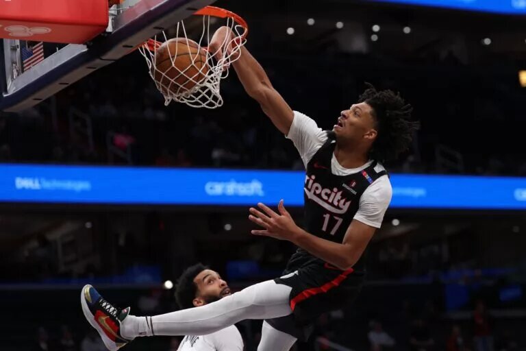 Portland Trail Blazers guard Shaedon Sharpe (17) dunks the ball over Washington Wizards forward Justin Champagnie (9) in the first half at Capital One Arena.