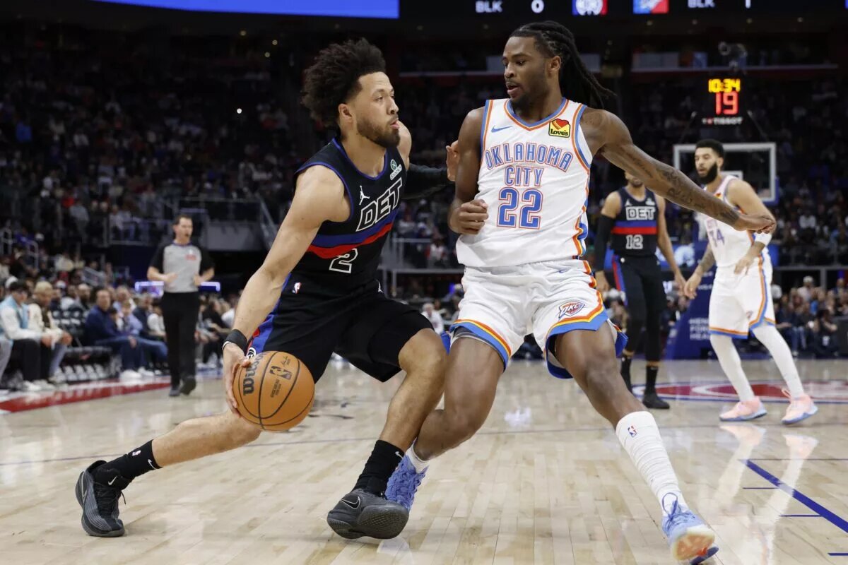 Detroit Pistons guard Cade Cunningham (2) dribbles defended by Oklahoma City Thunder guard Cason Wallace (22)