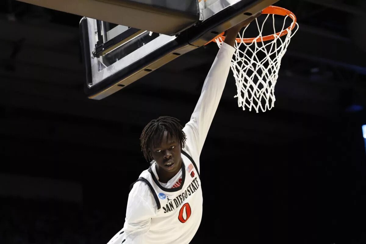San Diego State Aztecs forward Magoon Gwath (0) hangs from the basket