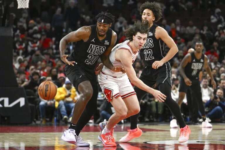 Dec 2, 2024; Chicago, Illinois, USA; Chicago Bulls guard Josh Giddey (3) loses the ball to Brooklyn Nets center Day'Ron Sharpe (20) and forward Jalen Wilson (22) during the second half at the United Center.