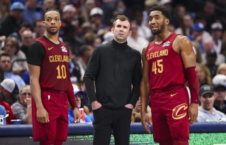 Jan 3, 2025; Dallas, Texas, USA; Cleveland Cavaliers head coach Kenny Atkinson speaks with Cleveland Cavaliers guard Darius Garland (10) and Cleveland Cavaliers guard Donovan Mitchell (45) during the first half against the Dallas Mavericks at American Airlines Center. Mandatory Credit: Kevin Jairaj-Imagn Images