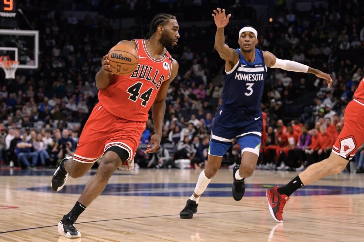Feb 5, 2025; Minneapolis, Minnesota, USA; Chicago Bulls forward Patrick Williams (44) dribbles the ball against Minnesota Timberwolves forward Jaden McDaniels (3) during the first quarter at Target Center. Mandatory Credit: Nick Wosika-Imagn Images