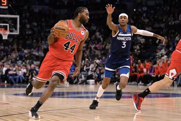 Feb 5, 2025; Minneapolis, Minnesota, USA; Chicago Bulls forward Patrick Williams (44) dribbles the ball against Minnesota Timberwolves forward Jaden McDaniels (3) during the first quarter at Target Center. Mandatory Credit: Nick Wosika-Imagn Images