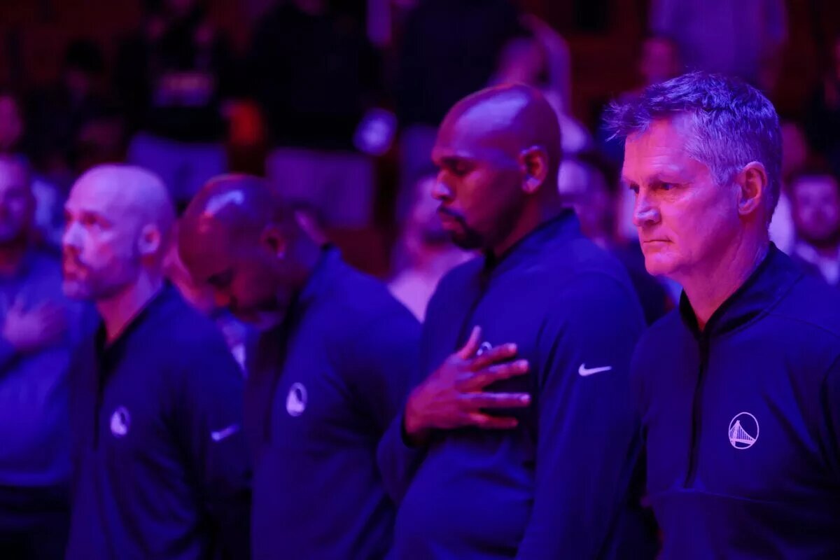 Feb 13, 2025; Houston, Texas, USA; Golden State Warriors head coach Steve Kerr (far right) and his assistant coaches stand for the national anthem before playing against the Houston Rockets at Toyota Center. Mandatory Credit: Thomas Shea-Imagn Images Jonathan Kuminga Injury