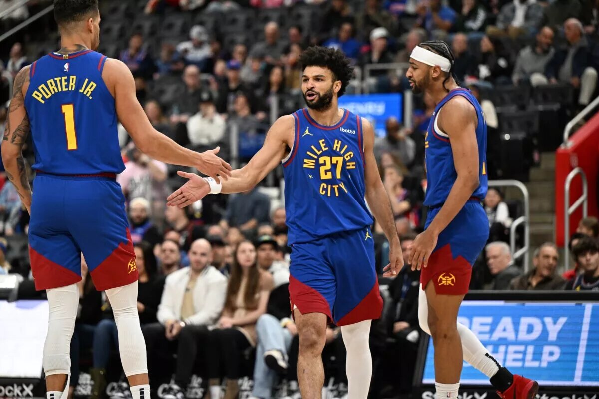 Feb 28, 2025; Detroit, Michigan, USA; Denver Nuggets guard Jamal Murray (27) celebrates with forwards Michael Porter Jr. (1) and Zeke Nnaji (22) after scoring and drawing a foul against the Detroit Pistons in the first quarter at Little Caesars Arena. Mandatory Credit: Lon Horwedel-Imagn Images